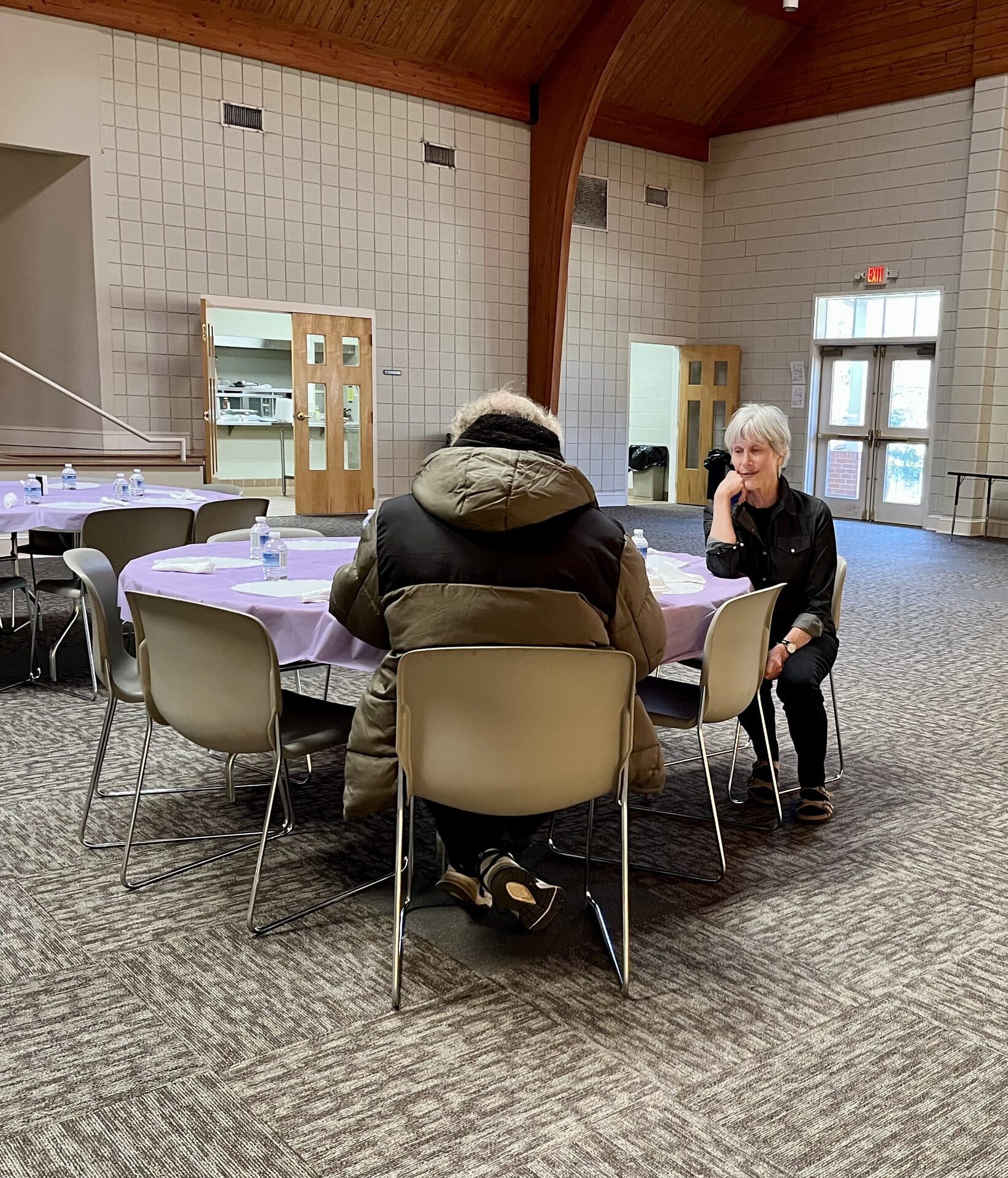 Volunteers and guests connecting over a shared meal