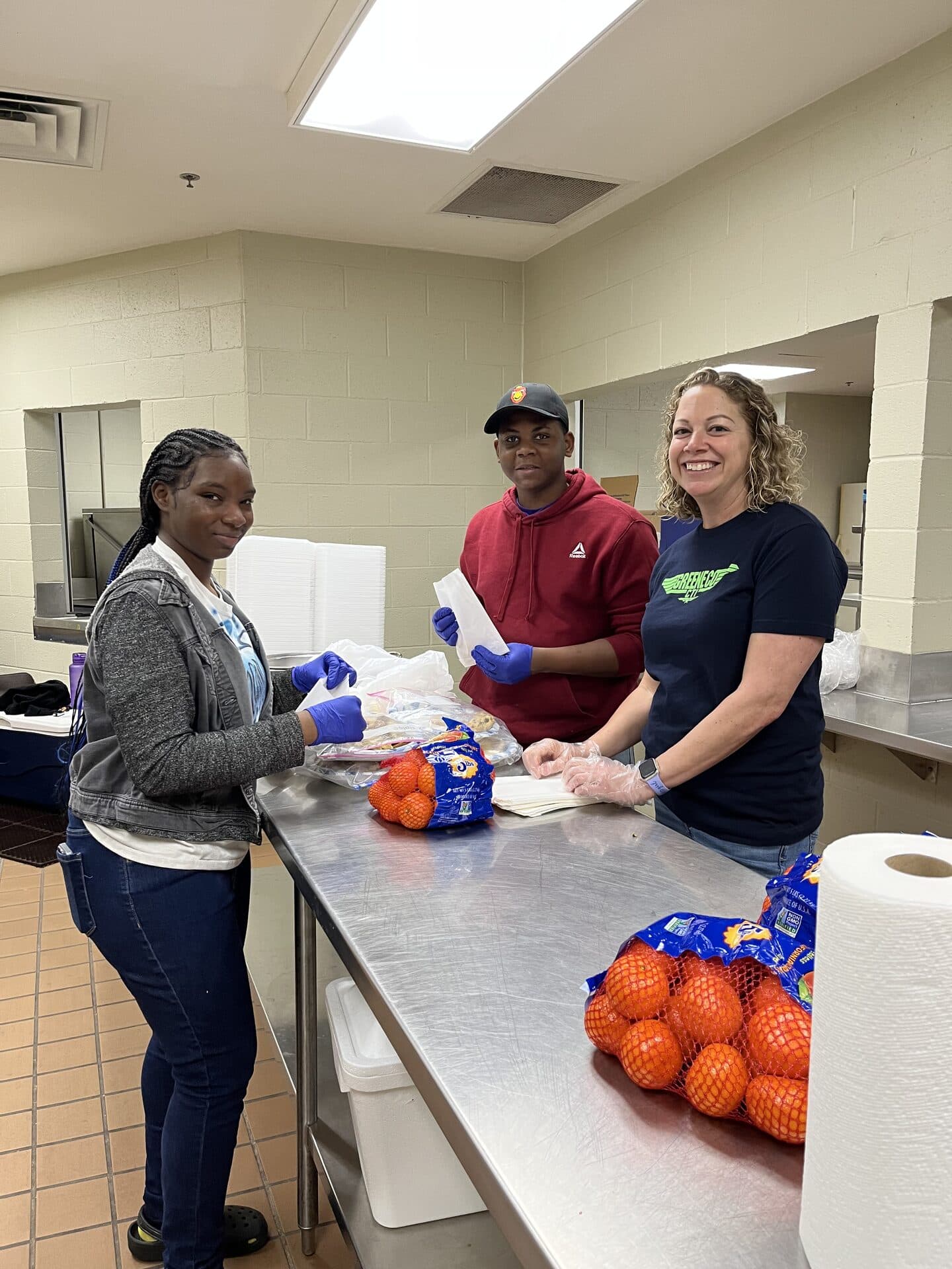 Youth volunteers helping serve meals to the community